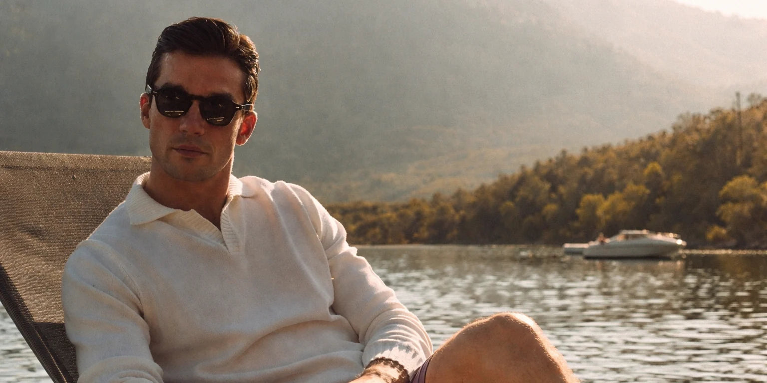 Man wearing sunglasses by the water