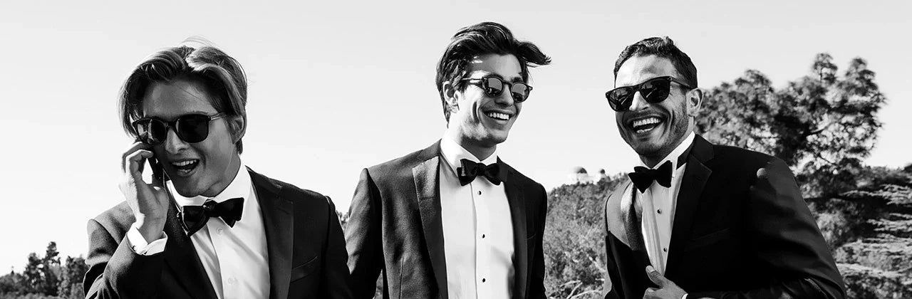 Men wearing tuxedos at an outdoor event